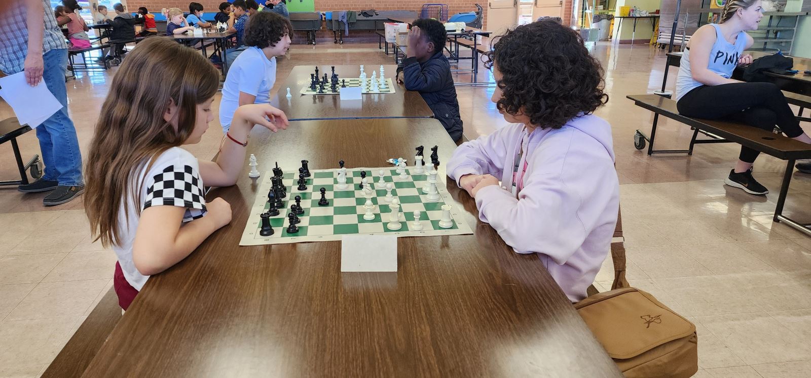 Two girls play chess