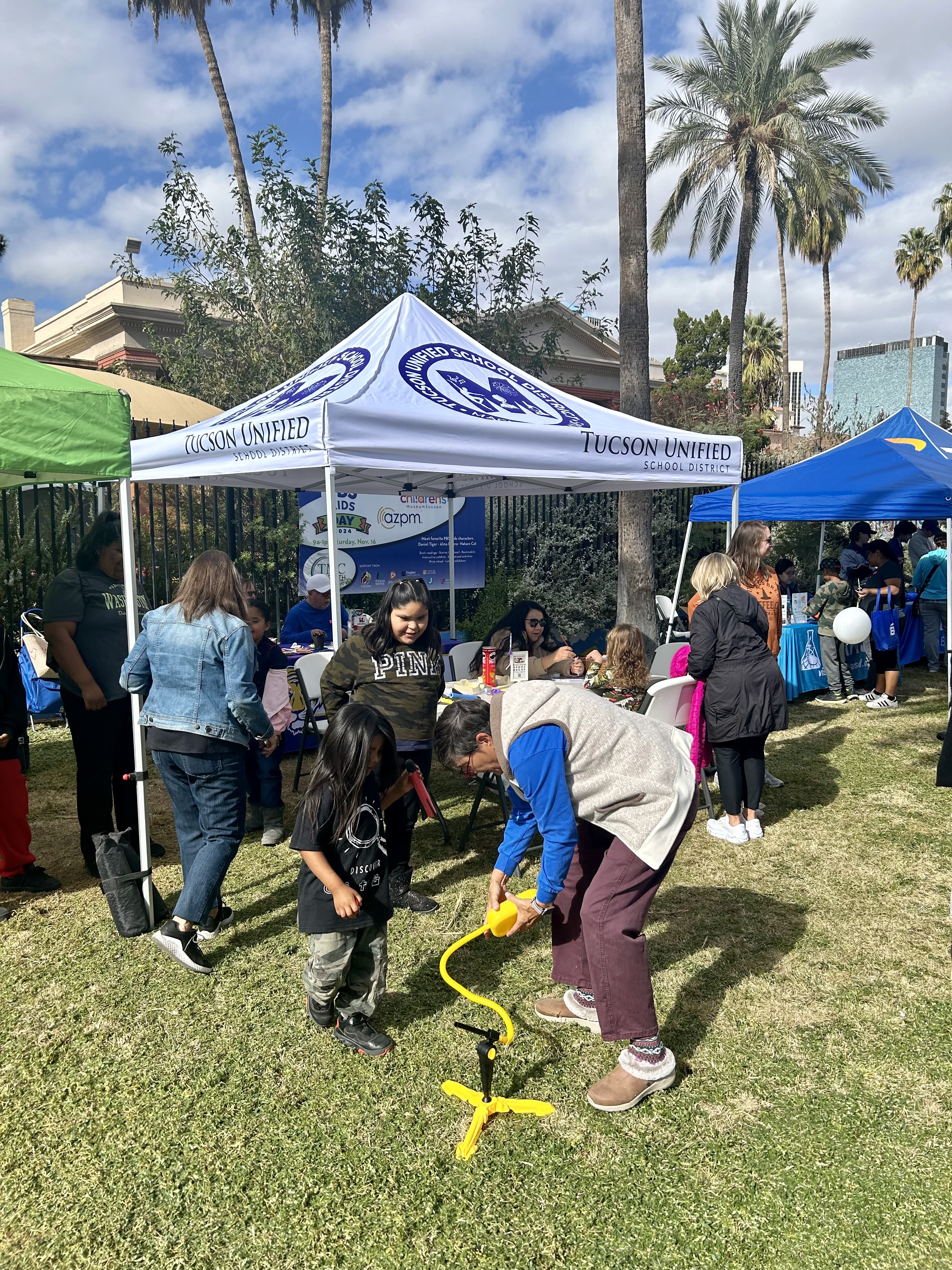 A boy plays with a fun STEM game at the TUSD Magnet tent