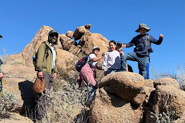 Students climb around on some rock formations