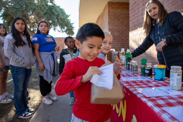 Child shows delight at opening a bag