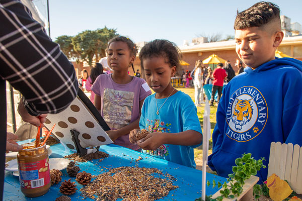 Children observe a seeding machine