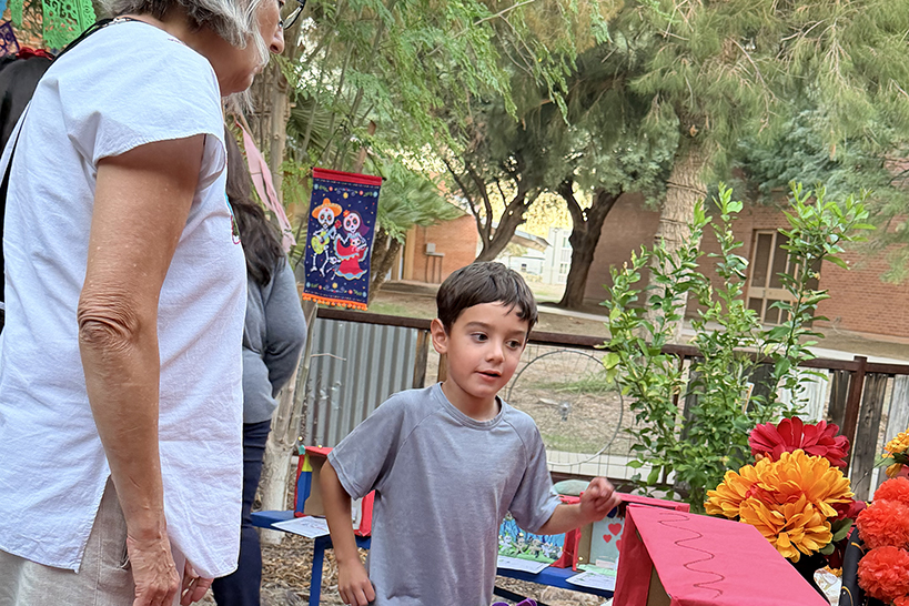 A little boy and a woman look at an art display
