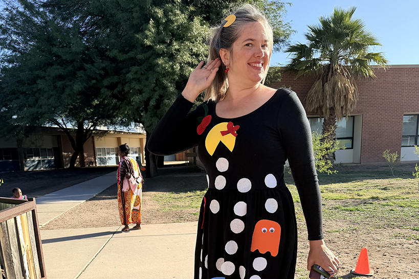 A woman shows off her Ms. Pacman dress