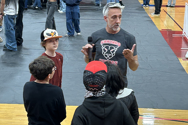A teacher talks to a group of his students