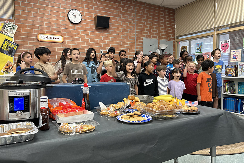 A group of students singing in the cafeteria